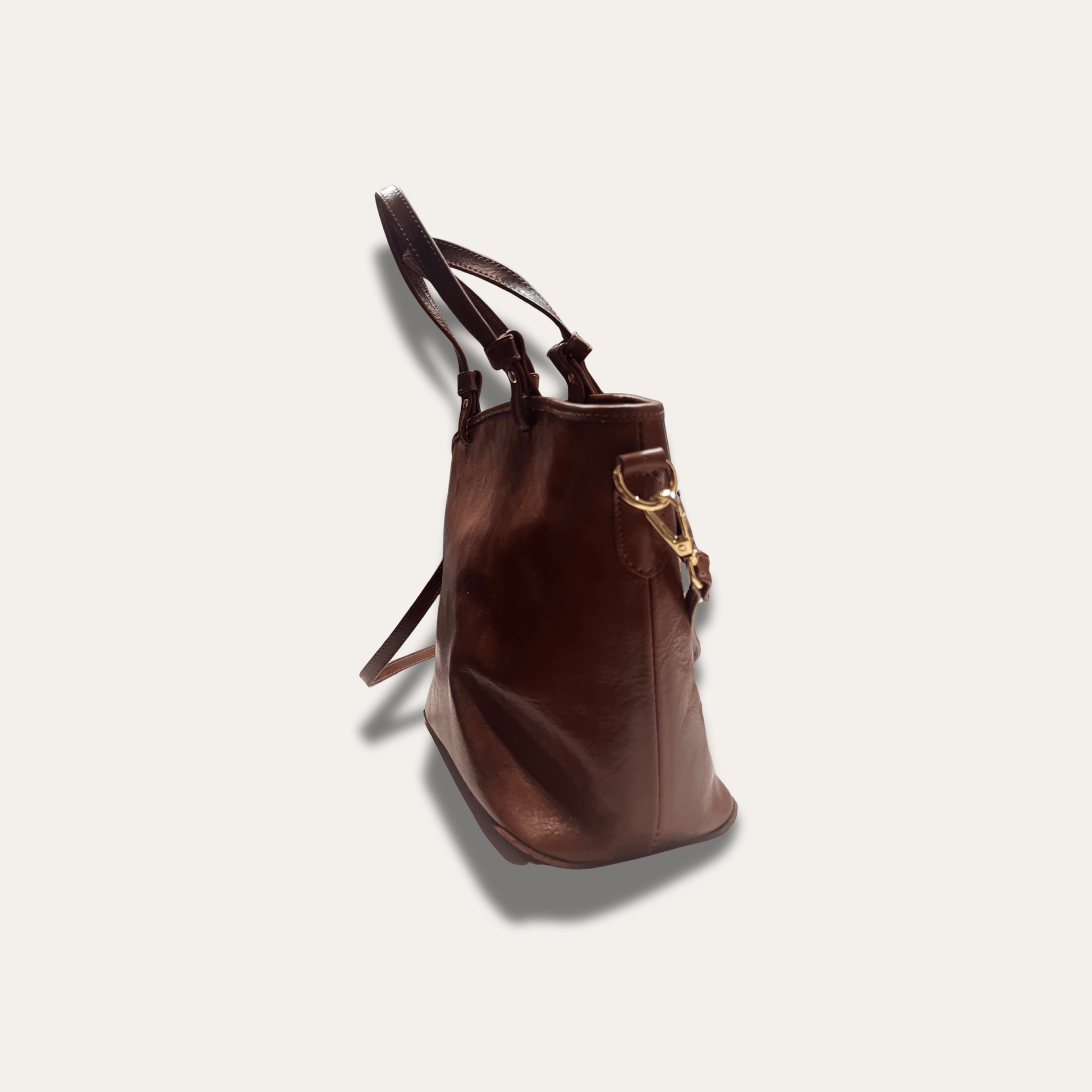 Anna Brown leather handbag, handcrafted since 1918, showcasing rich brown hues and elegant design.