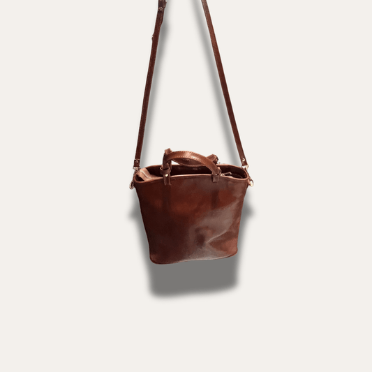 Leather handcrafted Anna Brown bag, stylish and durable, designed since 1918 for elegance and functionality.